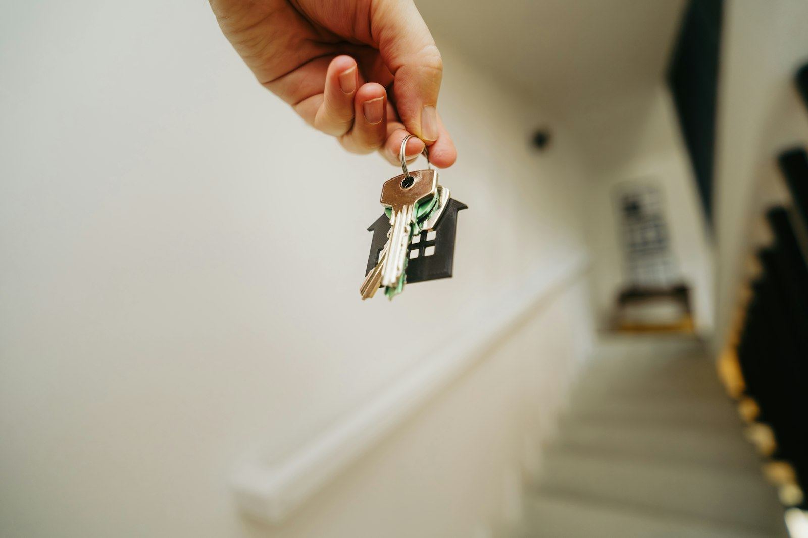 House keys held up in a hallway