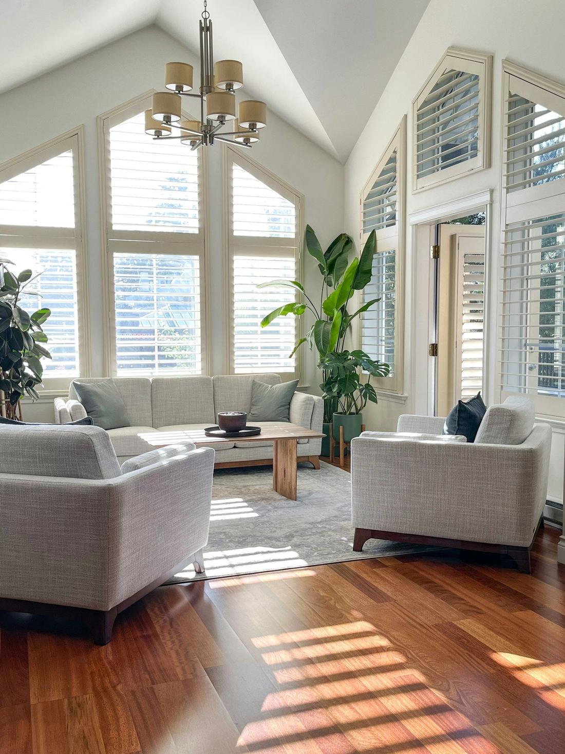 A bright rental living room with tall windows